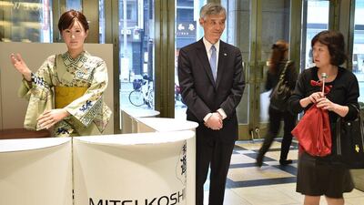 Humanoid ChihiraAico clad in a Japanese kimono greets a customer. AFP
