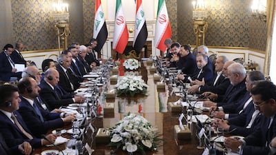 Mr Pezeshkian, centre right, and Mr Al Zaidi, centre left, attend a meeting in Tehran. EPA