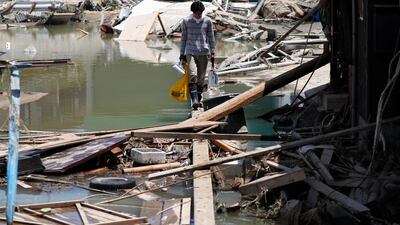 A local resident walks in a flooded area in Kurashiki, Okayama. Reuters