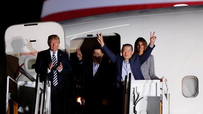 Two of the Americans formerly held hostage in North Korea gesture next to US President Donald Trump and first lady Melania Trump, upon their arrival at Joint Base Andrews, Maryland, US, on May 10, 2018. Jim Bourg / Reuters