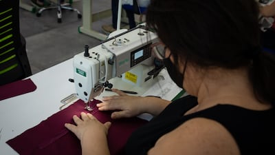 Rosette works a sewing machine in the academy area of the Diamony Group factory floor in Kaslik, Lebanon. Woman attended the academy course before deciding whether or not they want to work at the company. All photos: Oliver Marsden for The National