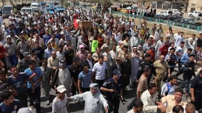 Friends and relatives mourn as they carry the coffin of Iraqi journalist Riyadh Al-Sarai during his funeral procession in Baghdad, Iraq, Tuesday, Sept. 7, 2010. Unknown gunmen in a speedy car intercepted the car of al-Sarai in Harithiya area of Baghdad and killed him by silenced pistols. (AP Photo/Khalid Mohammed)