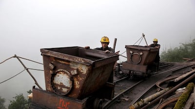 Iranian coal miners push metal carts to be loaded with coal at a mine near the city of Zirab. Ebrahim Noroozi / AP Photo