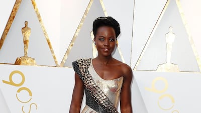 METALLICS: The Black Panther’s Lupita Nyong’o went for gold in asymmetric Atelier Versace. EPA