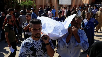 People carry a body at Nasser hospital of a Palestinian who was killed in the incident on Wednesday in Khan Younis. Reuters