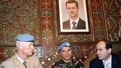 Upon arrival in Damascus Maj Gen Robert Mood, left, speaks with the Syrian foreign ministry employee Mohammed Al Mohammed, right, and Col Ahmed Himmiche, the UN advance team leader.