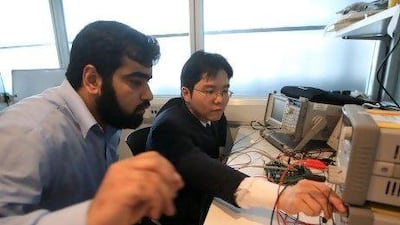 Jeraid Yoo, right, assistant professor in microsystems engineering, and his student Muhammad Awais bin Altaf, test the ECG microchip bandage.