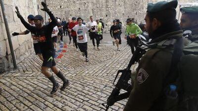 Israeli border policemen stand guard as runners take part in the Jerusalem Winner Marathon last year. Ronen Zvulun / AFP