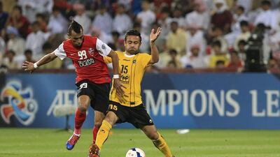 Al Ahli’s Ciel, left, tries to steal the ball from Omid Ibrahim of Sepahan during their match at Rashid Stadium in Dubai on Tuesday night. Sarah Dea / The National
