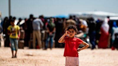 A displaced Syrian girl from Ras Al Ain stands at the Washukanni camp in Syria's northeastern Hasakeh province. AFP