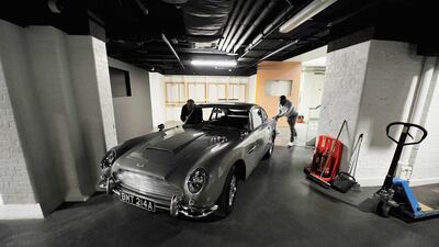 An Aston Martin DB5 used in the film Goldeneye is loaded in to the London Film Museum ahead of the Bond in Motion exhibition, opening 21st March at the London Film Museum on March 2, 2014 in London, England.