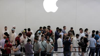 Customers queue outside the Apple store at Dubai Mall. Mahmoud Khaled / EPA