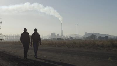Workers walk past a Lonmin’s Marikana platinum mine. Differences over possible job cuts in South Africa’s platinum mines emerged on Tuesday as mining union AMCU prepared to sign a three-year wage deal with the world’s top producers of the metal to end a crippling five-month strike. Skyler Reid / Reuters
