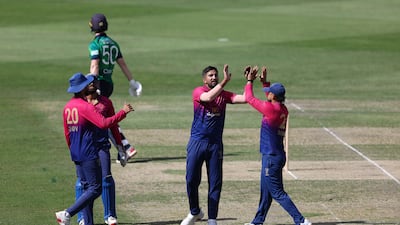 UAE's Junaid Siddique celebrates taking the wicket of Ireland's George Dockrell