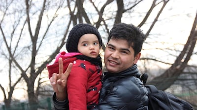 A man holding a child walks with others to the border gate of Pazarkule in Edirne, near Turkey-Greece border. AP