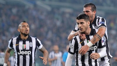 Alvaro Morata of Juventus celebrates with teammates after scoring against Real Madrid on Tuesday night in the Champions League. Alessandro Di Marco / EPA