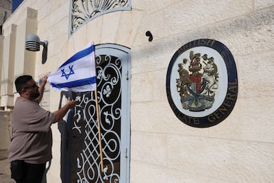 An Israeli flag is placed on the British consulate in East Jerusalem during a protest. EPA