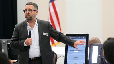 Eric Coomer from Dominion Voting demonstrates his company's touchscreen tablet in Grovetown, Georgia. Atlanta Journal-Constitution via AP