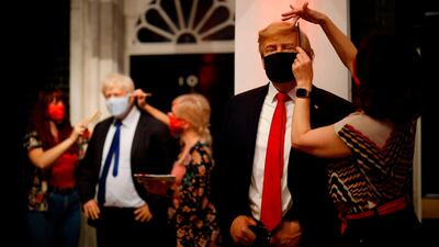 Artists apply finishing touches to wax figures of Britain's Prime Minister Boris Johnson and US President Donald Trump at Madame Tussauds in London. Tolga Akmen / AFP