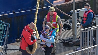 Border Force officers escort 40 migrants into Dover on May 6, 2022. EPA