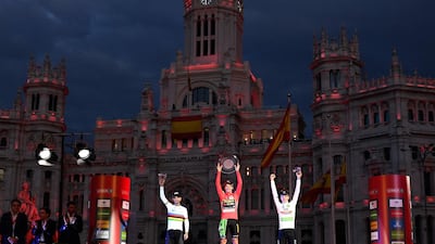 All three celebrate under the night sky of Madrid. AFP