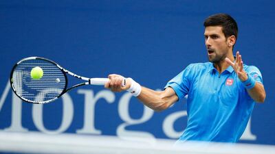 Novak Djokovic of Serbia hits a return to Stan Wawrinka of Switzerland. Kena Betancur / AFP