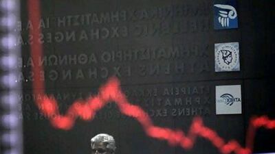 A chart shows stock prices at the Greek Stock Exchange in Athens. In Brussels, finance ministers were expected to discuss Greece's unravelling debt crisis. Petros Giannakouris / AP Photo