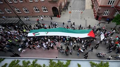 The rally marched with a giant flag. EPA