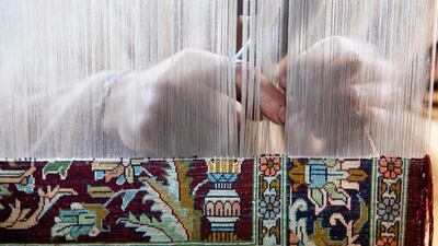 A Kashmiri craftsman works on a carpet loom in Magam, near Srinagar. The fine wool and silks used by the weavers make the Kashmir carpets quite expensive. Reuters