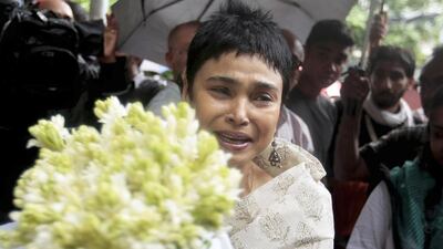 A woman brings flowers to pay respect to the people who died at Holey Artisan Bakery in Dhaka's Gulshan area. The assault on the restaurant in the capital's diplomatic zone marks an escalation in militant violence in the nation. (AP Photo)