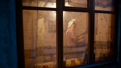A woman washes up dishes in her kitchen in the yard of a house in the village of Vesyoloye. Alexander Zemlianichenko / AP Photo