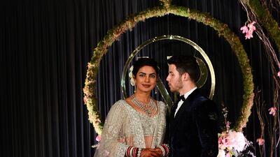 Newlyweds Priyanka Chopra, 36, and Nick Jonas, 26, pose for a photograph during a reception at a hotel in New Delhi on December 4, 2018. Photo: AFP