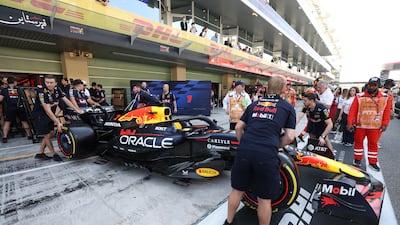 The Red Bull team move Max Verstappen's car on race day at Yas Marina Circuit