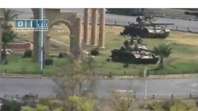 Tanks are seen stationed in the city of Hama in this still image taken from video posted on a social media website. Social Media Website via Reuters TV