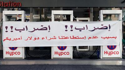 A banner at a Beirut petrol station reads: "Strike!! Strike!! Because we can't buy the US dollar". Reuters