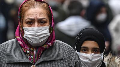 People wearing face masks walk in the symp market in Gaziosmanpasa in Istanbul. AFP