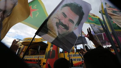 Cheering supporters hold posters of the imprisoned Kurdish rebel leader Abdullah Ocalan in southeastern Turkey. AP