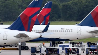 Luggage sits on the tarmac by gates at Orlando International Airport. Red Huber / Orlando Sentinel via AP
