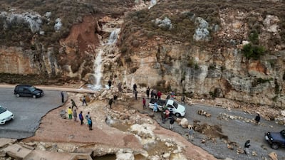 People stranded on a road after heavy rainfall caused a landslide near Shahhat city, in north-eastern Libya. Reuters