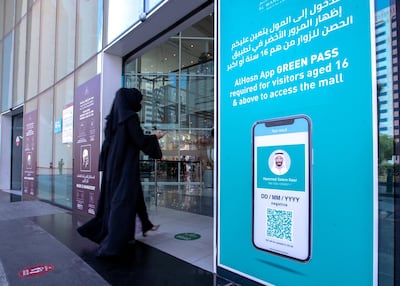 Al Hosn Green Pass awareness signs are put up at Al Wahda Mall, Abu Dhabi. Victor Besa / The National