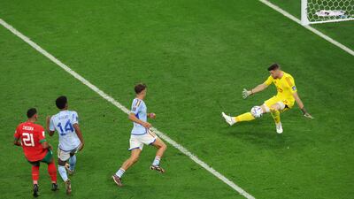 Unai Simon of Spain makes a save against Walid Cheddira of Morocco. Getty