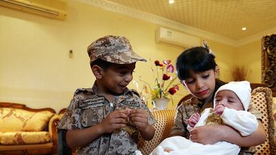 Waleed Al Dhanhani’s children, Ahmed, 3, Dana, 7, and Waleed, who was born a month after his father’s death. Satish Kumar / The National