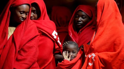 A migrant child intercepted off the coast in the Mediterranean Sea waves as she waits to disembark from a rescue boat at the port of Malaga, southern Spain. Reuters