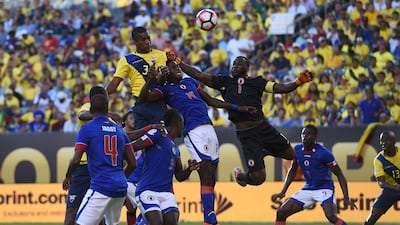 Ecuador’s Frickson Erazo rises tallest to head the ball ahead of Haiti’s James Marcelin (14) and Haiti goalkeeper Johnny Placide during their Copa America Centenario football match in East Rutherford, New Jersey. Don Emmert / AFP