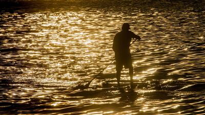 A man on a paddle board on the River Main, Frankfurt. Frank Rumpenhorst / EPA