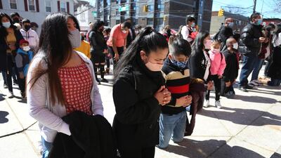 Parishioners kneel during a Mass relayed by loudspeaker outside Our Lady of Sorrows in the Queens borough of New York City. Rev Manuel Rodriguez says more than 100 parishioners of the Roman Catholic church have died from coronavirus. AP