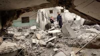 Policemen survey a Hamas outpost destroyed after an Israeli air strike in Khan Younis in the southern Gaza Strip.