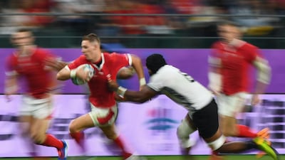 Wales' full back Liam Williams (L) runs past Fiji's flanker Dominiko Waqaniburotu during the Japan 2019 Rugby World Cup Pool D match between Wales and Fiji at the Oita Stadium in Oita. AFP