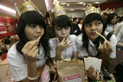 A group of girls eating their burgers in Jakarta, Indonesia on April 26, 2007. Bloomberg