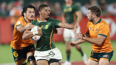 Shilton Van Wyk, centre, of South Africa in action during the Emirates Dubai 7s Rugby tournament final against Australia on 4 December, 2021. EPA